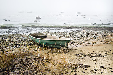 Image showing Old fishing boat at coast foggy in the morning