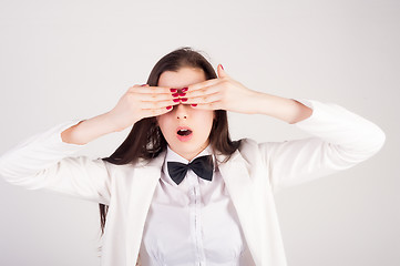 Image showing shocked young woman with closwd eyes