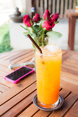 Image showing Relaxing time with fresh iced orange juice 