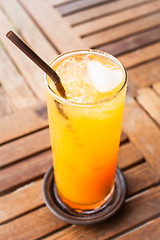 Image showing Fresh orange juice with heart ice cube 