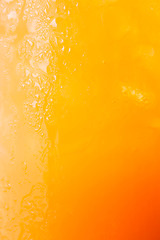 Image showing Fizzy glass of iced orange juice up close 