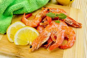 Image showing Shrimps on board with lemon