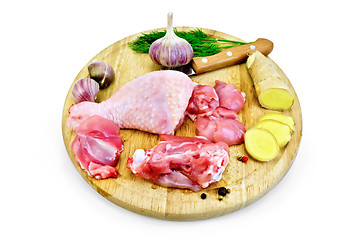 Image showing Chicken leg cut on a round board