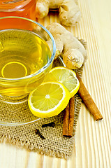 Image showing Tea ginger on a burlap with honey and lemon