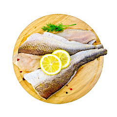 Image showing Fillet of codfish on a round board with dill