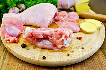 Image showing Chicken leg cut on a wooden board