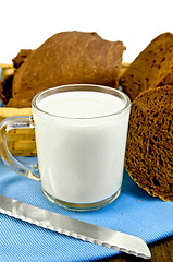 Image showing Milk in a glass goblet with rye bread