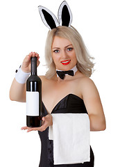 Image showing Waitress in bunny suit shows a bottle of wine