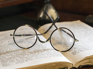 Image showing Old glasses on antique book