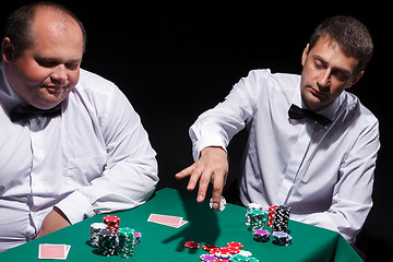 Image showing Two gentlemen in white shirts, playing cards