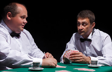 Image showing Two gentlemen in white shirts, playing cards