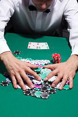 Image showing Gentleman in white shirt, playing cards