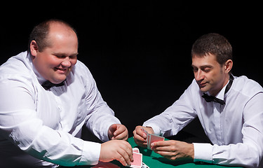 Image showing Two gentlemen in white shirts, playing cards