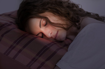 Image showing Woman Sleeping in a Red Pillow