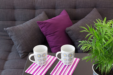 Image showing Sofa with cushions and two cups on a table