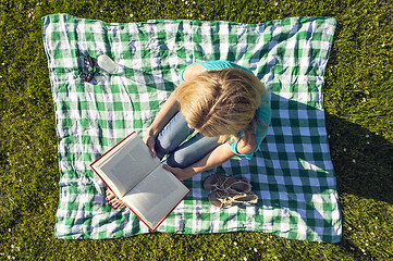 Image showing Young Woman Reading Book In Park, seen from above