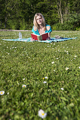 Image showing Young Woman Reading Book In Park