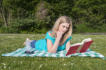 Image showing Young Woman Reading Book In Park
