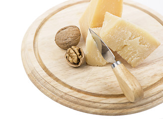 Image showing Nuts and cheese on wooden board.