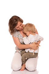 Image showing Young boy sitting on mother lap