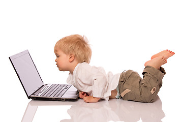 Image showing Young boy looking at a laptop