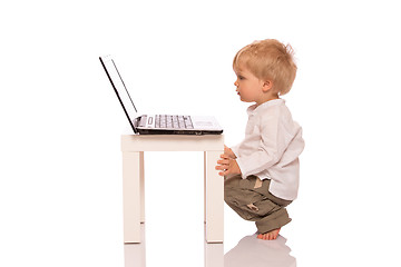 Image showing Young boy looking at a laptop