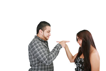 Image showing Young couple pointing at each other against a white background 