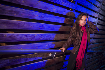 Image showing Mixed Race Young Adult Woman Against a Wood Wall Background
