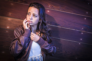 Image showing Frightened Pretty Young Woman in Dark Walkway at Night