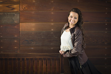 Image showing Mixed Race Young Adult Woman Portrait Against Wooden Wall