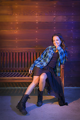 Image showing Mixed Race Young Adult Woman Portrait Sitting on Wood Bench