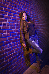 Image showing Pretty Mixed Race Young Adult Woman Against a Brick Wall