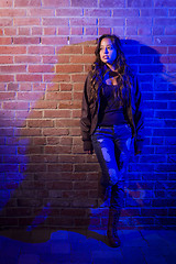 Image showing Pretty Mixed Race Young Adult Woman Against a Brick Wall