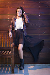 Image showing Mixed Race Young Adult Woman Portrait Against Wooden Wall