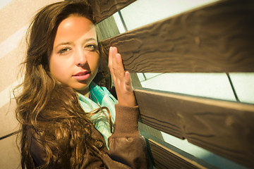 Image showing Mixed Race Young Adult Woman Against a Wood Wall Background