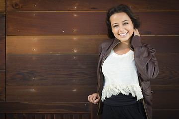 Image showing Mixed Race Young Adult Woman Portrait Against Wooden Wall