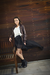 Image showing Mixed Race Young Adult Woman Portrait Against Wooden Wall