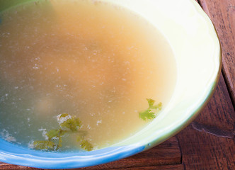 Image showing Hot clear soup boiled from pork in ceramic bowl 