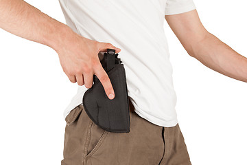 Image showing Close-up of a man with his hand on a gun