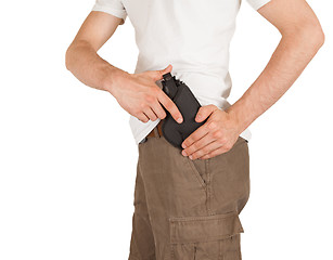 Image showing Close-up of a man with holster and a gun