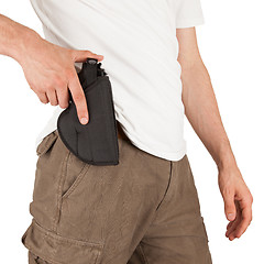 Image showing Close-up of a man with his hand on a gun