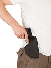 Image showing Close-up of a man with his hand on a gun