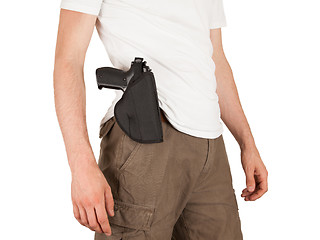 Image showing Close-up of a man with holster and a gun