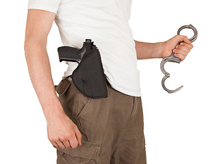 Image showing Close-up of a man with holster and a gun