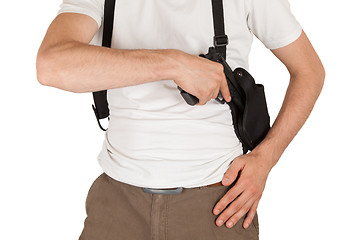 Image showing Close-up of a man with holster and a gun