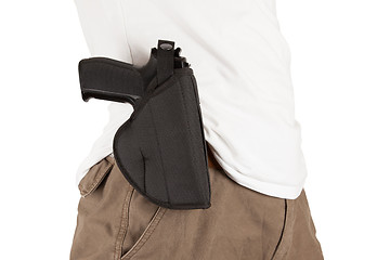 Image showing Close-up of a man with holster and a gun