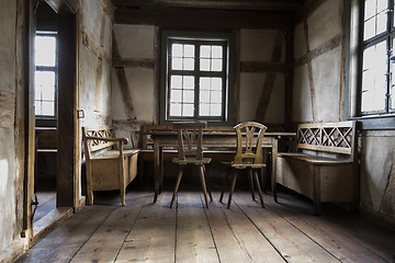 Image showing rustic chamber with bench, table and chair.