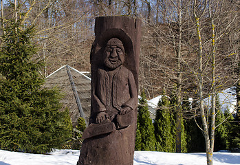 Image showing rural wooden carved man statue snow winter park 