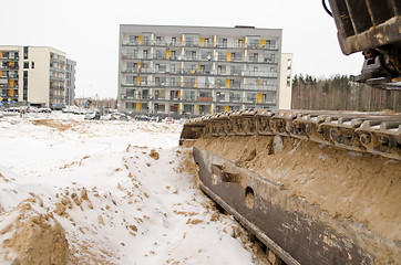 Image showing heavy machinery caterpillar  cars houses snow 