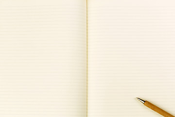 Image showing Wooden ballpoint pen on open notebook